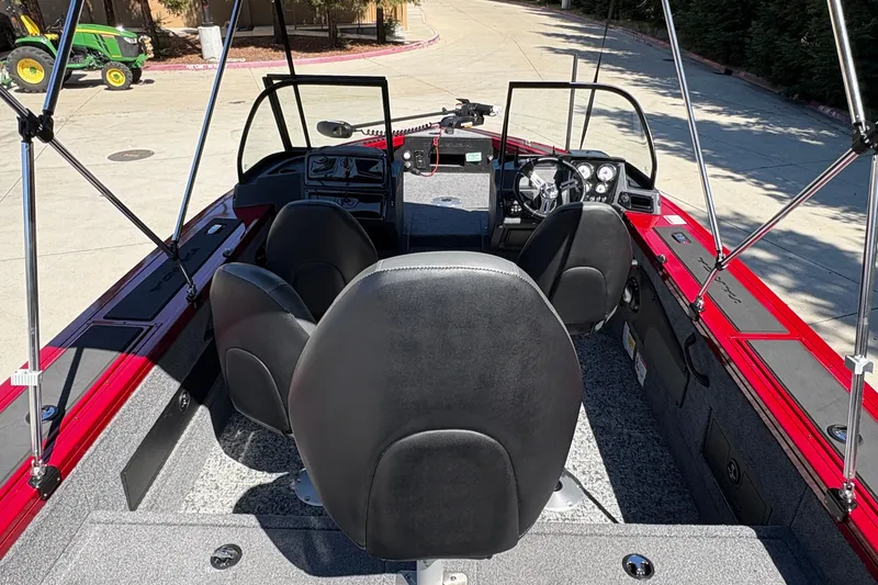 Slide: The Image of 2026 Tracker Targa V-18 WT boat interior with black seats and red accents. - 17