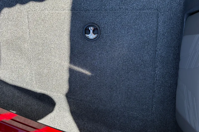 Slide: The Image of Carpeted floor of 2026 Tracker Targa V-18 WT boat with circular latch detail. - 52