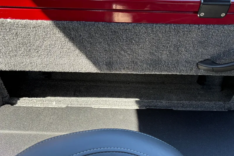 Slide: The Image of Interior view of 2026 Tracker Targa V-18 WT boat, featuring carpeted storage area. - 32