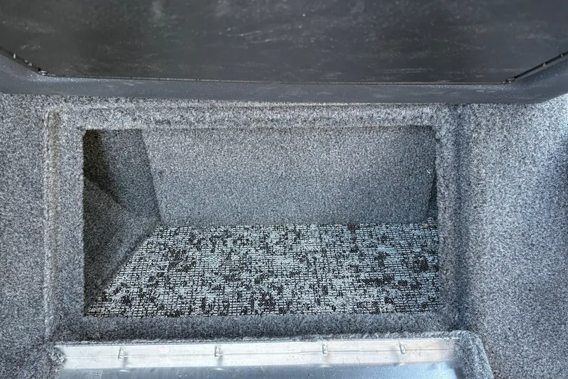 Slide: The Image of Storage compartment in 2026 Tracker Targa V-18 WT boat, featuring carpeted interior. - 40