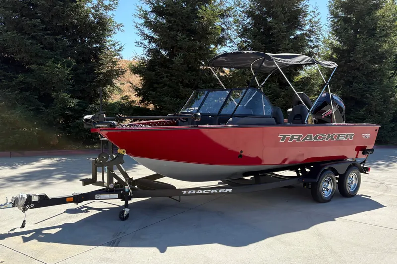 Slide: The Image of 2026 Tracker Targa V-18 WT boat on trailer, parked outdoors. - 2
