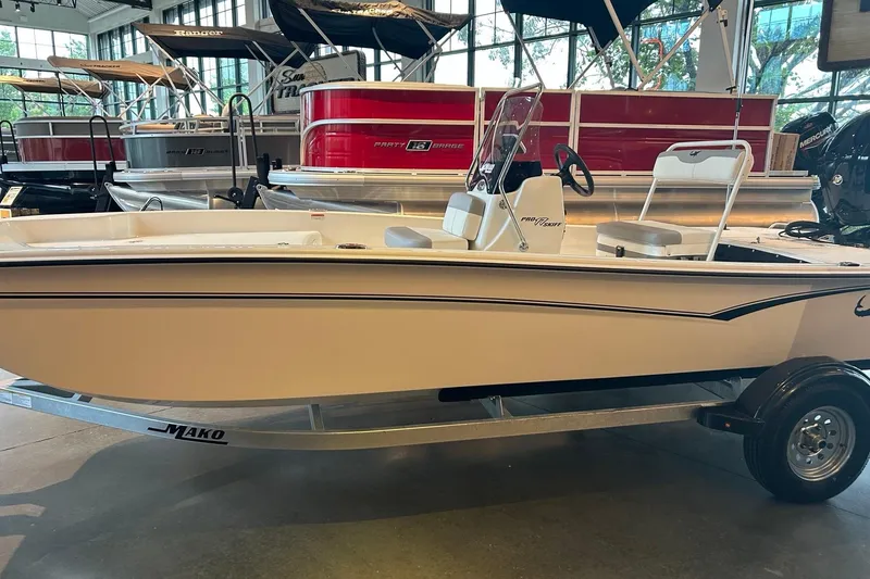 The Image of 2026 Mako Pro Skiff 17 CC boat displayed indoors on a trailer. - 0
