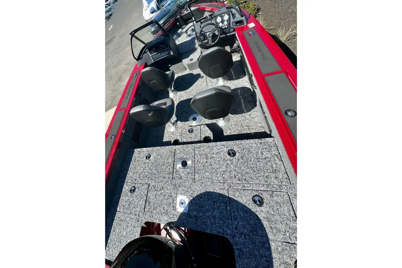 Slide: The Image of 2026 Tracker Targa V-18 WT boat interior with seating and dashboard, featuring red accents. - 83