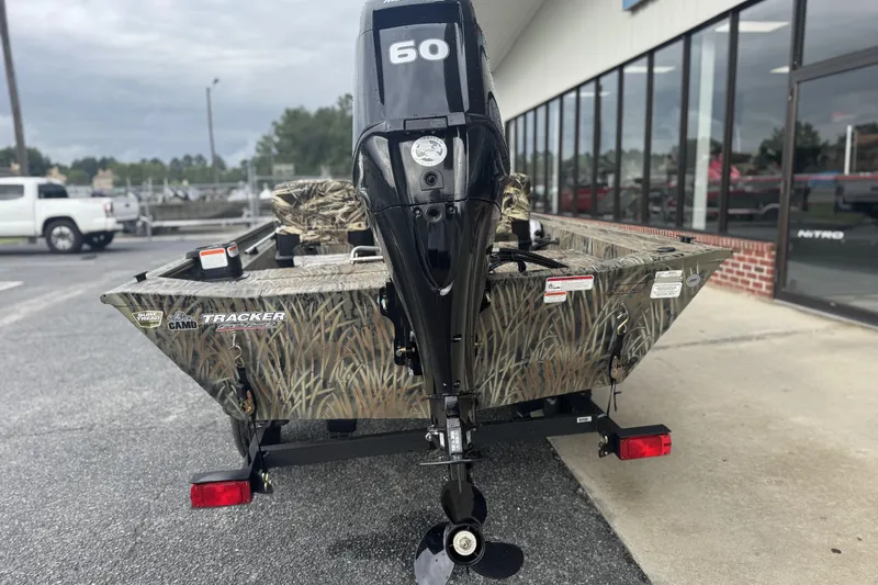 Slide: The Image of 2026 Tracker Grizzly 1754 SC boat with camouflage design and 60 HP motor. - 33