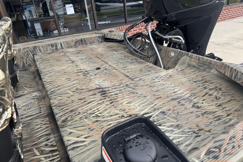 Slide: The Image of 2026 Tracker Grizzly 1754 SC boat with camouflage design and outboard motor. - 35