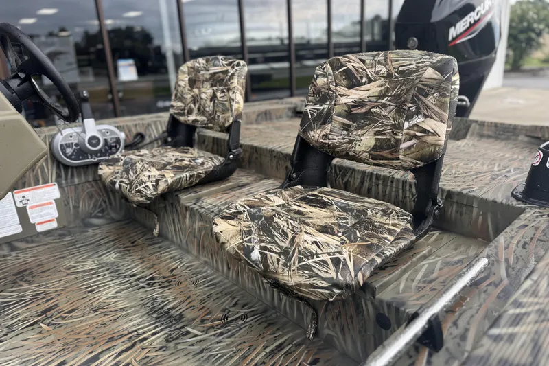 Slide: The Image of 2026 Tracker Grizzly 1754 SC boat with camo seats and steering console. - 36