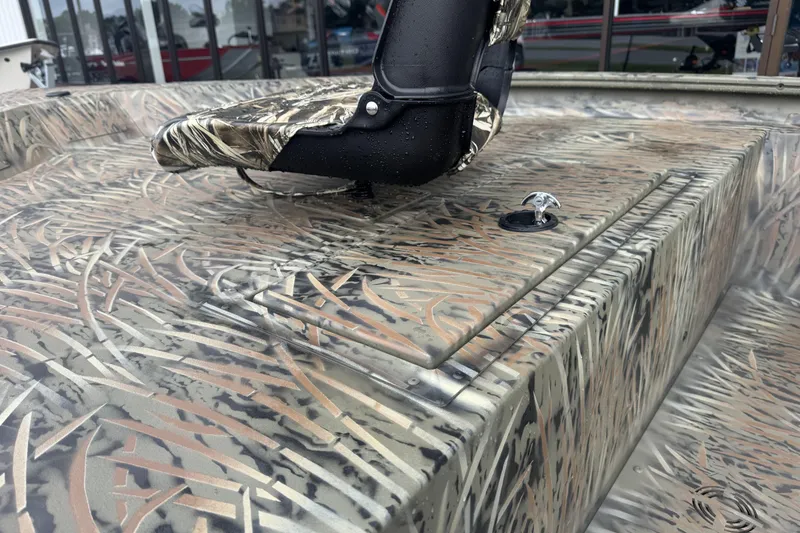 Slide: The Image of 2026 Tracker Grizzly 1754 SC boat with camouflage seating and textured deck design. - 39