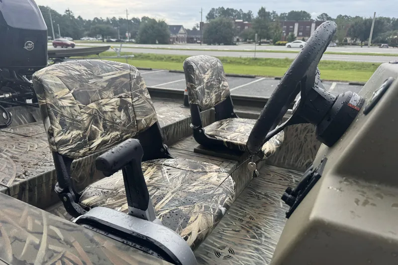 Slide: The Image of 2026 Tracker Grizzly 1754 SC boat interior with camo seats and steering wheel. - 47