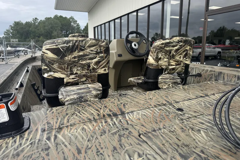 Slide: The Image of 2026 Tracker Grizzly 1754 SC boat with camo seats and steering console. - 50