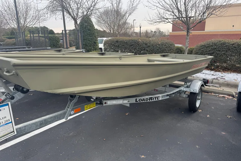 The Image of 2026 Tracker Grizzly 14 Jon boat on Load Rite trailer in parking lot. - 0