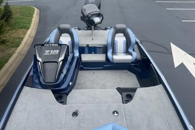 Slide: The Image of 2026 Nitro Z18 Pro boat with dual seats and sleek design in a parking lot. - 4