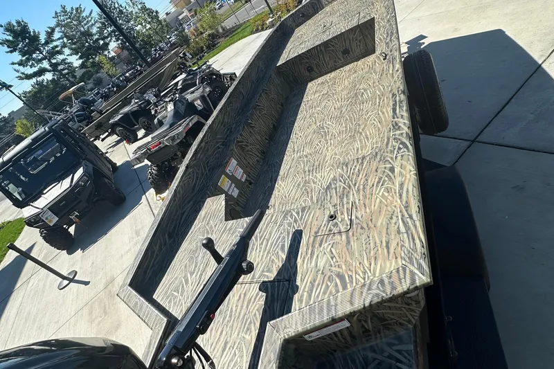 Slide: The Image of 2026 Tracker Grizzly 1650 T Prairie Wings Edition boat with camouflage design on display. - 2
