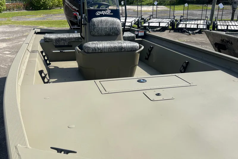Slide: The Image of 2026 Tracker Grizzly 1860 CC boat interior with camo seats and spacious deck. - 2