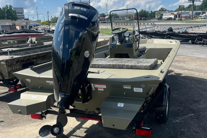 Slide: The Image of 2026 Tracker Grizzly 1860 CC boat with powerful outboard motor, parked outdoors. - 3