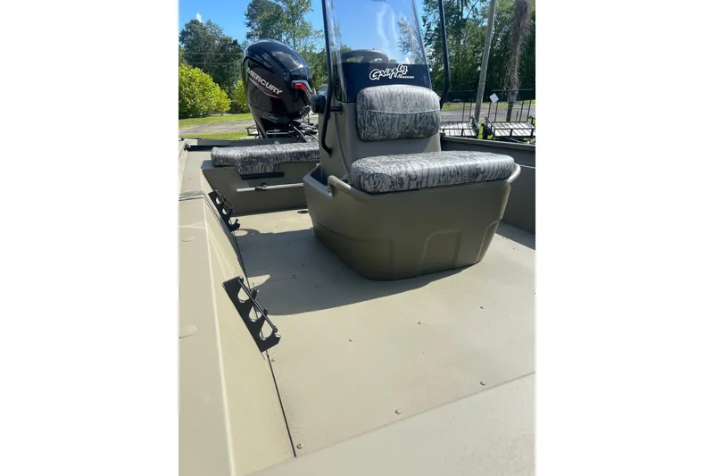 Slide: The Image of 2026 Tracker Grizzly 1860 CC boat interior with camo seats and Mercury outboard motor. - 8