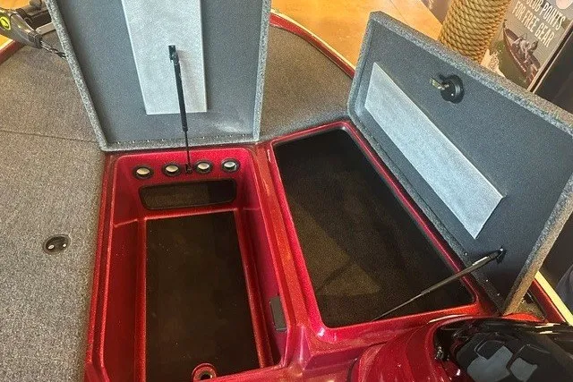 Slide: The Image of Open storage compartments in a 2026 Nitro Z17 boat, featuring carpeted interiors. - 9