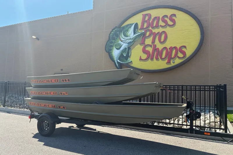 The Image of 2026 Tracker Grizzly 12 Jon boats stacked outside Bass Pro Shops. - 0