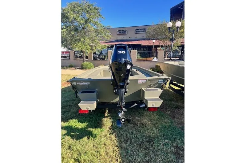 Slide: The Image of 2026 Tracker Grizzly 1654 T Sportsman boat with 30 HP motor, displayed outdoors. - 42