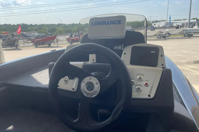 Slide: The Image of 2026 Tracker Pro Team 175 Crappie Edition boat dashboard with steering wheel and controls. - 7