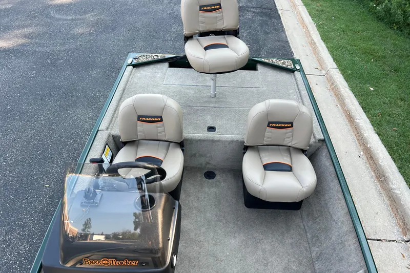 Slide: The Image of 2026 Tracker Bass Tracker Classic Limited boat with beige seats and steering console. - 4