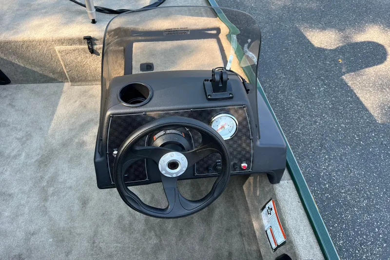 Slide: The Image of Steering console of 2026 Tracker Bass Tracker Classic Limited boat, featuring a gauge and cup holder. - 5