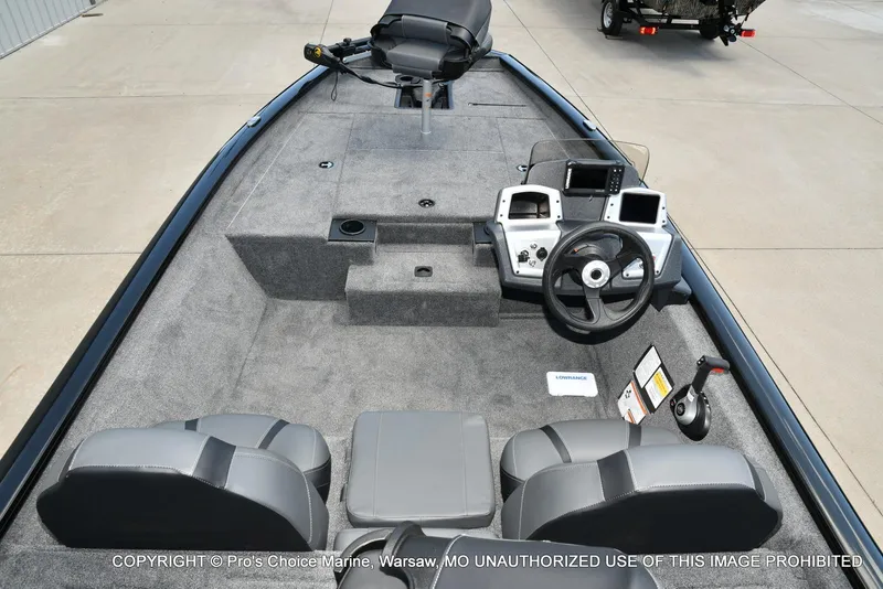 Slide: The Image of 2026 Tracker Pro Team 175 boat interior with steering console and seating. - 2