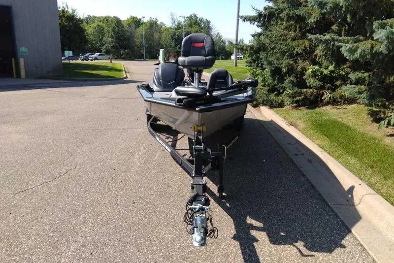 Slide: The Image of 2026 Tracker Pro Team 190 boat on trailer, parked on a sunny street. - 2
