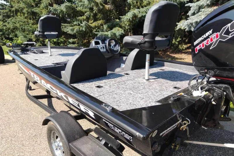 Slide: The Image of 2026 Tracker Pro Team 190 fishing boat with Mercury Pro XS engine, parked outdoors. - 4