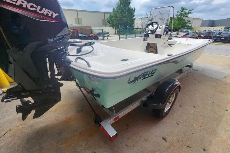 Slide: The Image of 2026 Mako Pro Skiff 17 CC boat on trailer with Mercury outboard motor. - 45