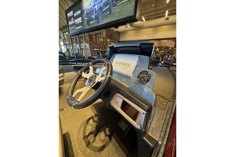 Slide: The Image of 2026 Nitro Z20 XL Pro boat dashboard with Garmin display and steering wheel. - 2