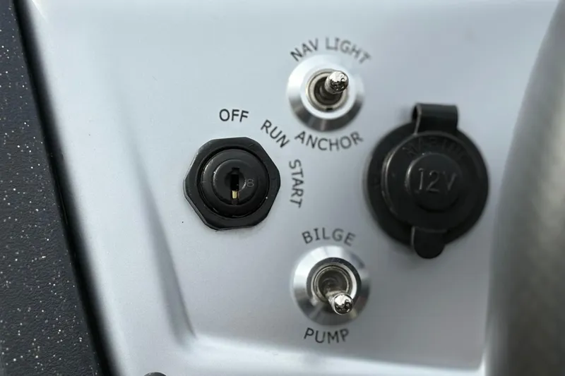 Slide: The Image of Control panel of 2026 Tracker Pro Team 175 Crappie Edition boat with switches and 12V outlet. - 17