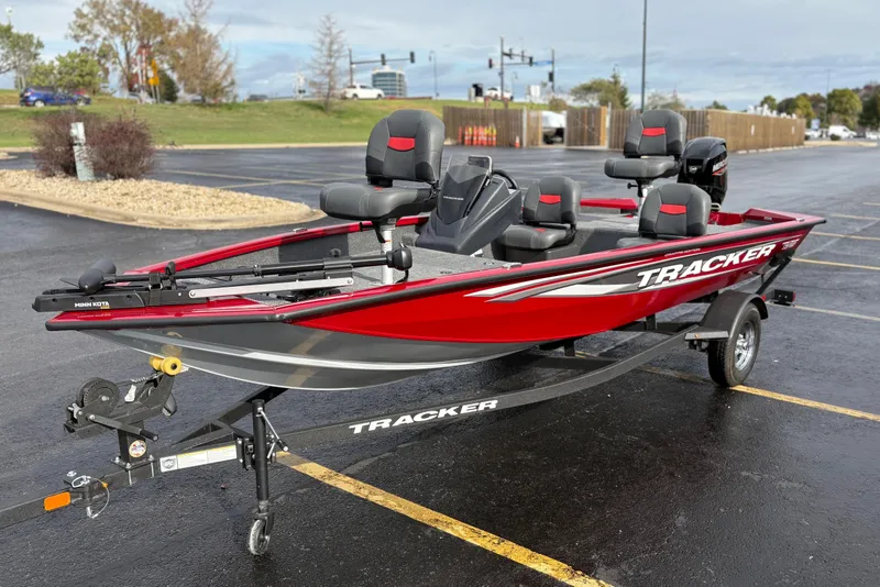 Slide: The Image of 2026 Tracker Pro Team 175 Crappie Edition boat in parking lot, red and gray design. - 3