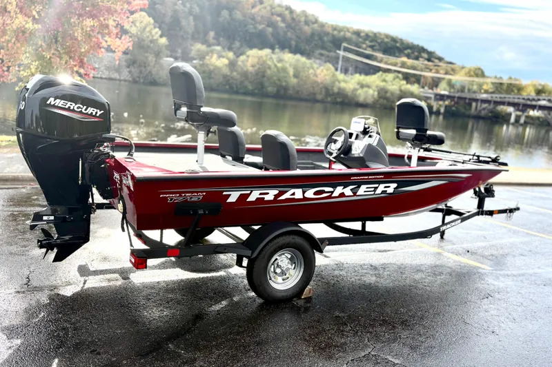 Slide: The Image of 2026 Tracker Pro Team 175 Crappie Edition boat with Mercury engine by a scenic river. - 4
