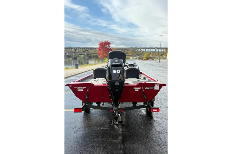 Slide: The Image of 2026 Tracker Pro Team 175 Crappie Edition boat with Mercury 60 engine, parked near a scenic bridge. - 7