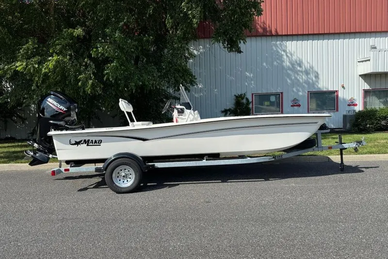 The Image of 2026 Mako Pro Skiff 17 CC boat on trailer, parked outdoors. - 0