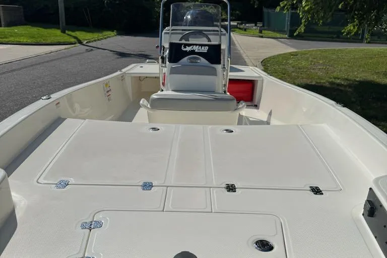 Slide: The Image of 2026 Mako Pro Skiff 17 CC boat interior with console and seating. - 10