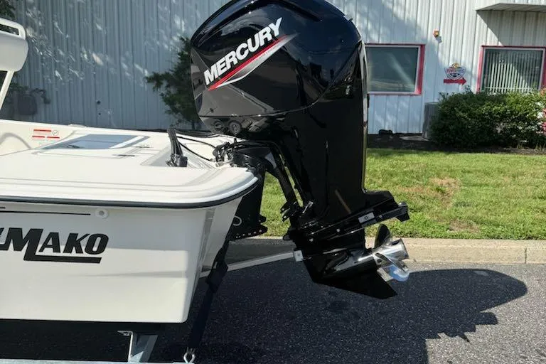 Slide: The Image of 2026 Mako Pro Skiff 17 CC with Mercury outboard motor, parked outdoors. - 3