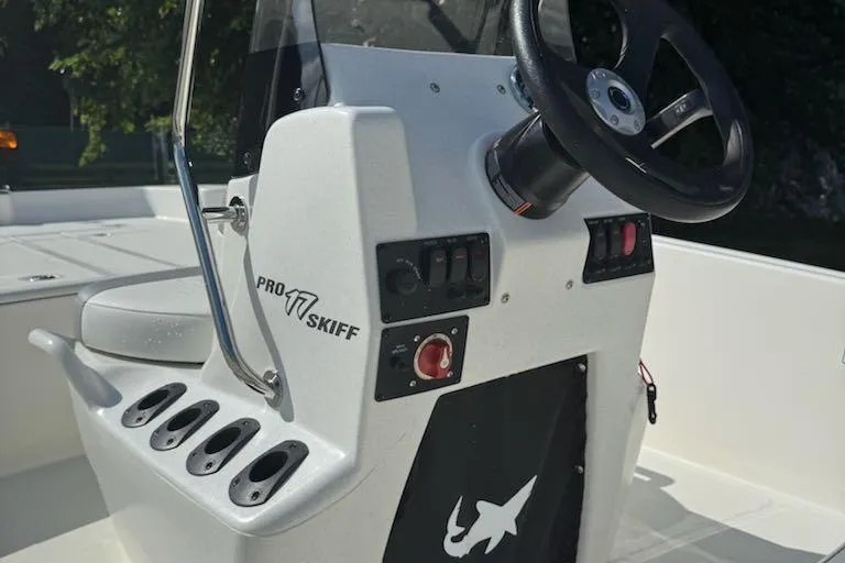 Slide: The Image of 2026 Mako Pro Skiff 17 CC boat console with steering wheel and control panel. - 9