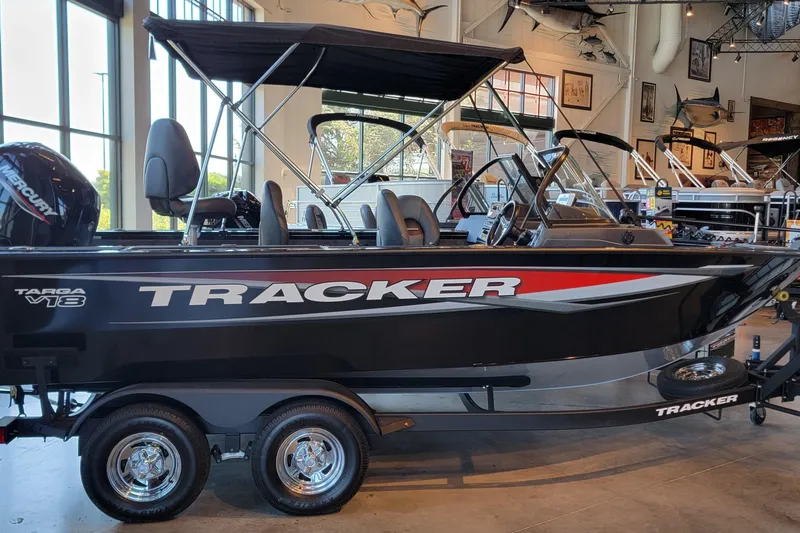 The Image of 2026 Tracker Targa V-18 WT boat in showroom, "We Take Trades" sign visible. - 0