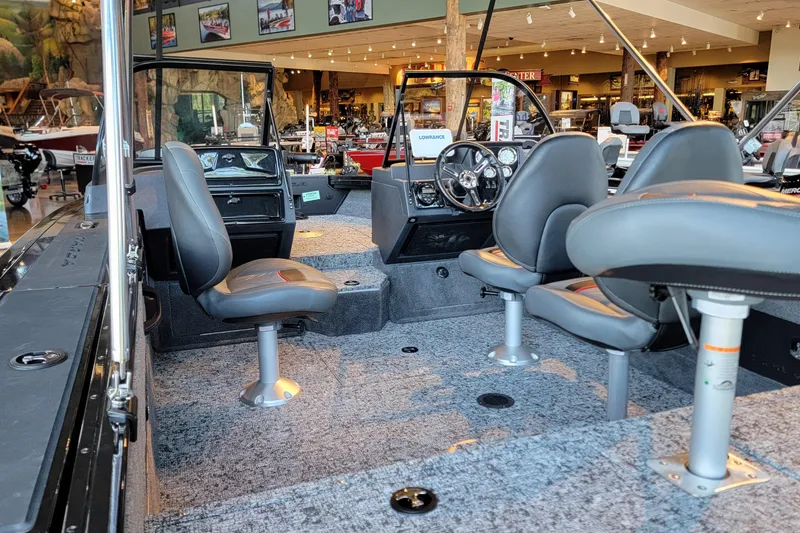 Slide: The Image of 2026 Tracker Targa V-18 WT boat with Mercury engine in showroom display. - 2