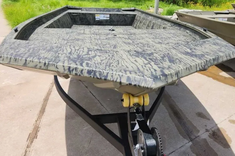 Slide: The Image of 2026 Tracker Grizzly 1860 Utility boat with camouflage design on a trailer. - 2