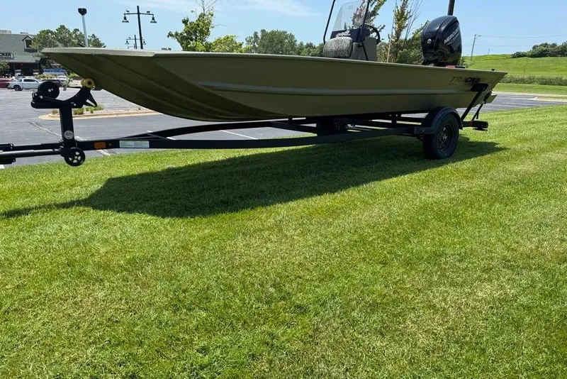 Slide: The Image of 2026 Tracker Grizzly 1860 Utility boat on trailer, parked on grass. - 10