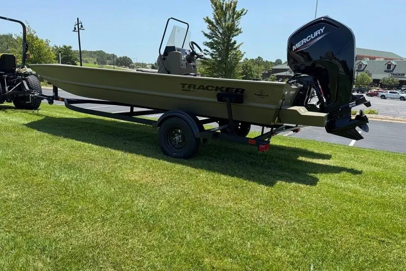 Slide: The Image of 2026 Tracker Grizzly 1860 Utility boat on trailer, featuring Mercury outboard motor. - 2
