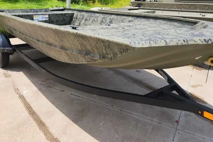 The Image of 2026 Tracker Grizzly 1860 Utility boat on trailer, showcasing rugged design and camouflage pattern. - 0