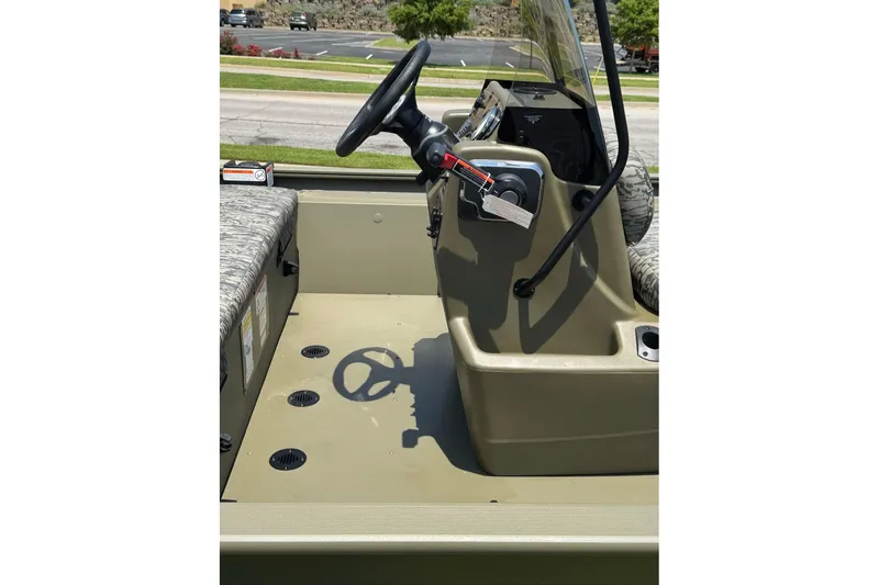 Slide: The Image of 2026 Tracker Grizzly 1860 Utility boat interior with steering console and seating. - 13