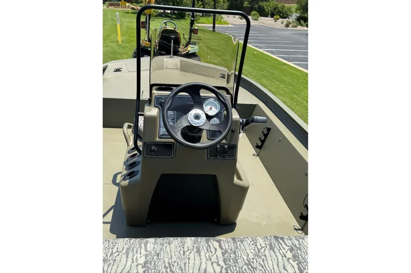 Slide: The Image of 2026 Tracker Grizzly 1860 Utility boat interior with steering wheel and control panel. - 16