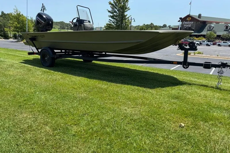 Slide: The Image of 2026 Tracker Grizzly 1860 Utility boat on trailer, parked on grass near Outdoor World. - 11