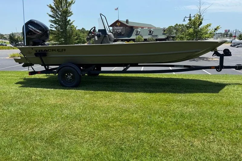 Slide: The Image of 2026 Tracker Grizzly 1860 Utility boat on trailer, parked on grass. - 4