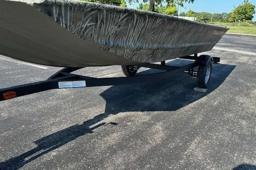 Slide: The Image of 2026 Tracker Grizzly 1648 Utility boat on trailer in parking lot. - 5