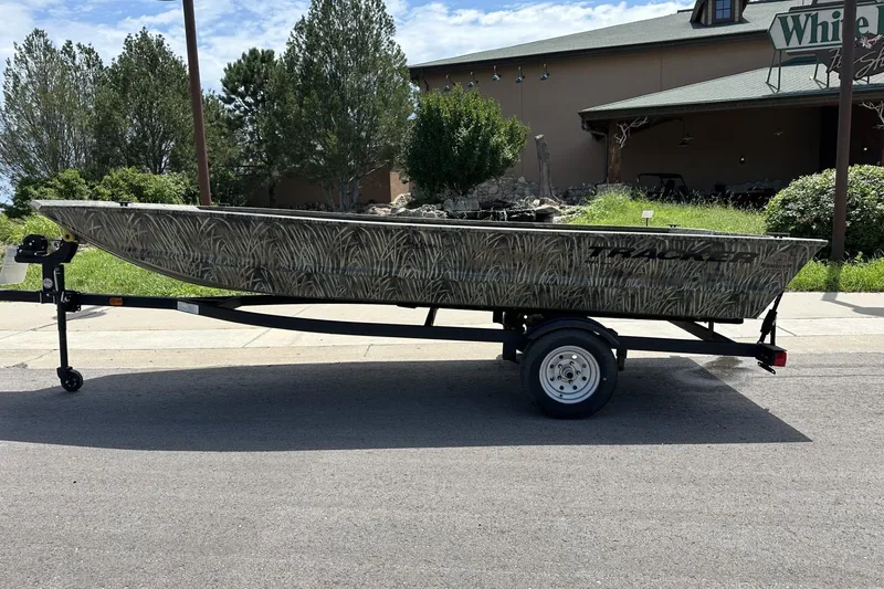 The Image of 2026 Tracker Grizzly 1648 Utility boat on trailer, parked outdoors. - 0